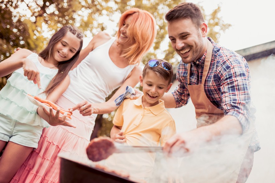Family celebrating Labour Day on a budget with a backyard barbecue